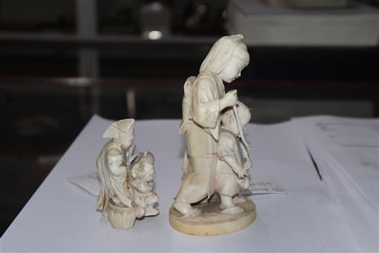 A Meiji carved ivory group of two children (damaged) on hardwood stand and a smaller group tallest 14cm incl. stand